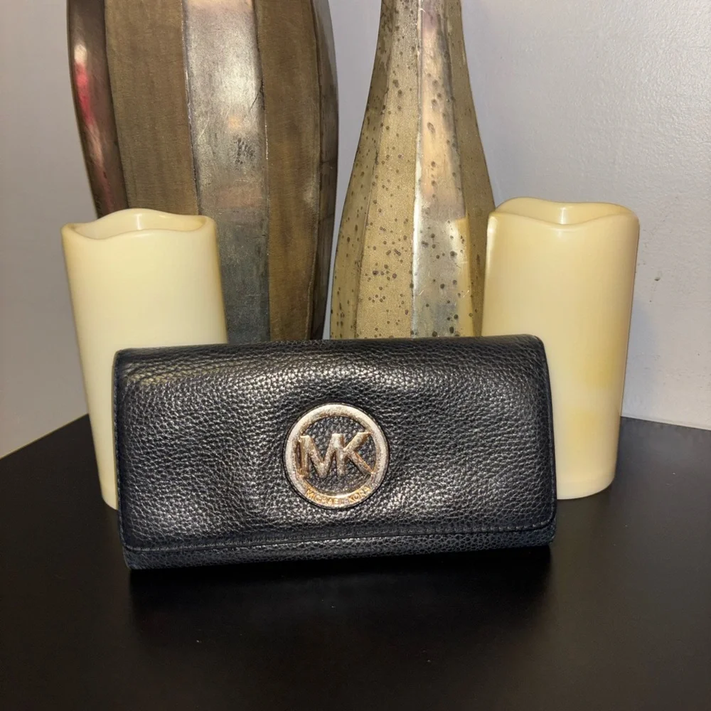 Michael Kors Fulton Large Flap Continental Wallet in black pebbled leather.